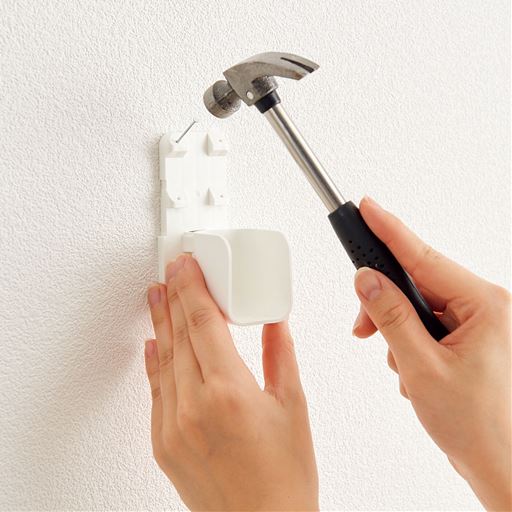 【取り付け方(1)】壁に竿受けを当て、固定用ピンで固定します。