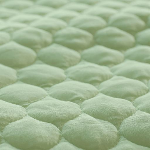 生地拡大(グリーン)<br>肌に触れる面に使用したのは、100%天然素材のコットンガーゼ。